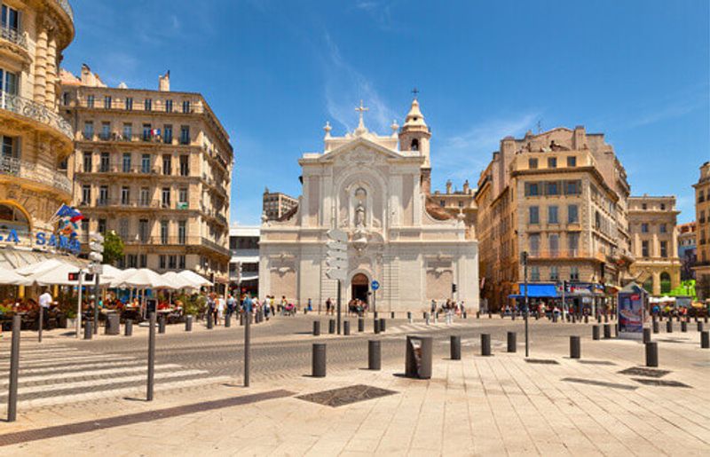 A view of the old port with a church, cafe's and restaurants visible.