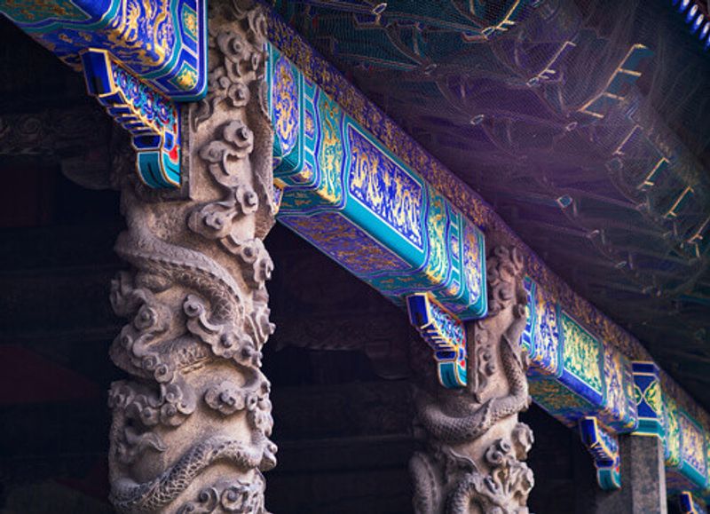 Artistic dragon pillars in front of Dacheng Hall in the Temple of Confucius, a UNESCO World Heritage Site.