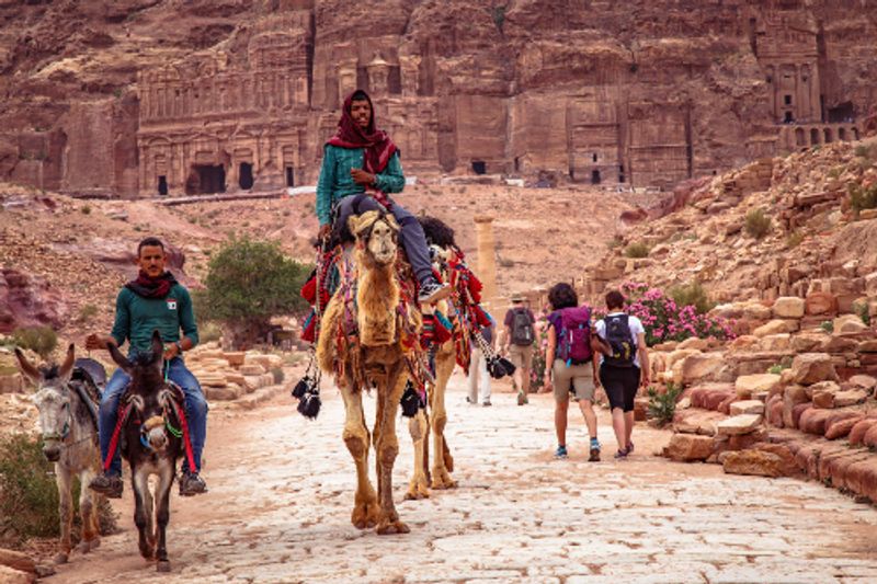 Bedouin men and their camels at the ancient ruins of Petra, Jordan.