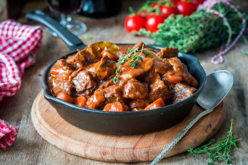 Beef Bourguignon Ragou with carrots and thyme in Burgundy.