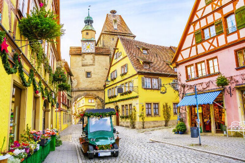 A retro car and old houses decorated for the Christmas holidays in Rothenburg ob der Tauber in Bavaria.