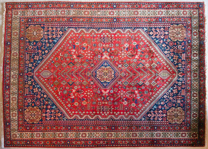 An Abadeh rug laid out.