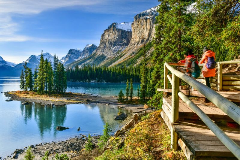 Tourists and locals alike enjoy the views of Beautiful Spirit Island at the boardwalk in Maligne Lake.
