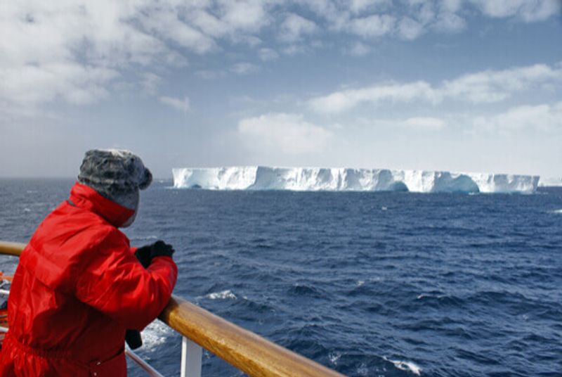 A person looks out to sea in Antarctica.