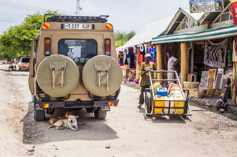 An off-road jeep resting on a street in the town of Arusha.