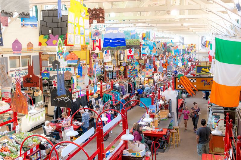 The busy Saint John City Market with colourful banners and decor.