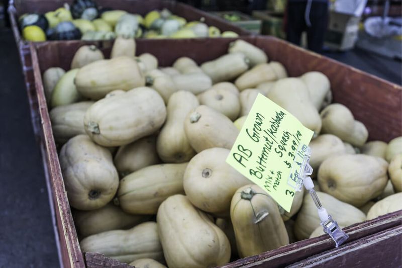 Visitors enjoy butternut squash on offer at a Farmer's Market in Calgary.