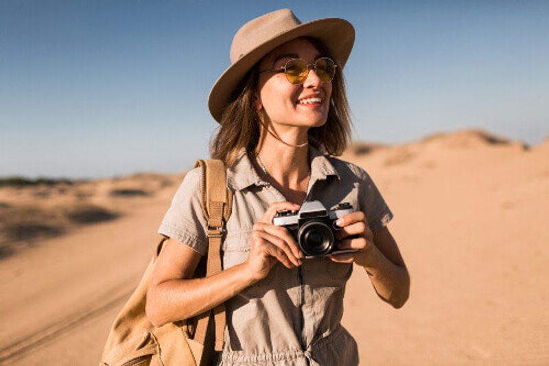 A happy tourist on a safari savannah.