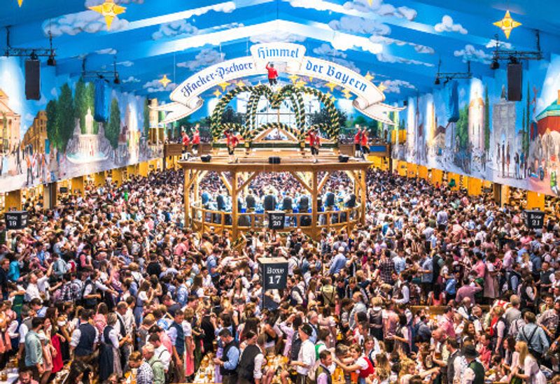 Famous beer tent called Hacker-Pschorr and a crowd at Oktoberfest.