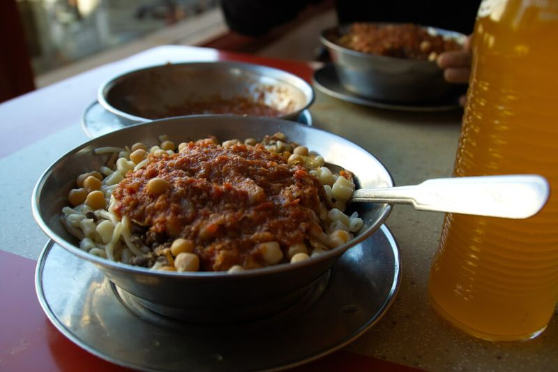 Koshary or Kushari is made from chickpeas, rice, tomato sauce, pasta, and lentils.