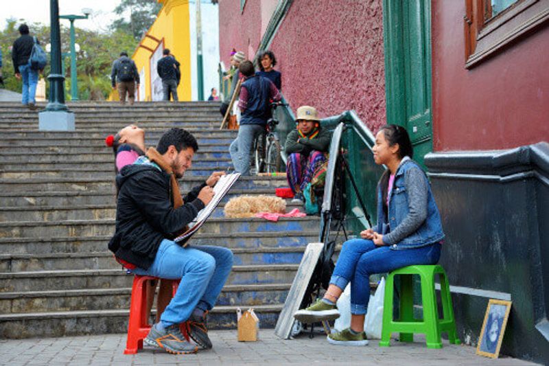 Tourist getting her face drawn in Barrio de Barranco in Lima.