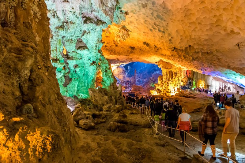 The Sung Sot Cave with tourists following the trail in Vietnam.