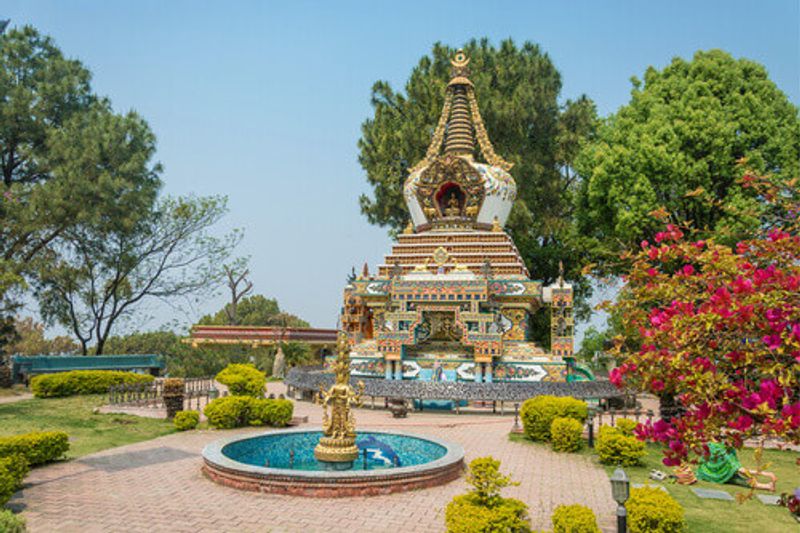 Stupa and the fountain in the park of the Buddhist Kopan Monastery in Kathmandu, Nepal.