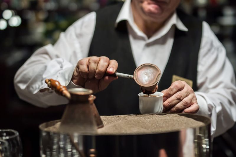 Traditional Turkish Coffee being cooked in the sand is a common sight in Turkey.