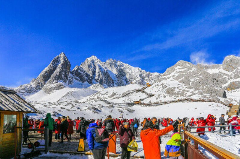 Tourists travel to the summit of the snow-capped Jade Dragon Snow Mountain.