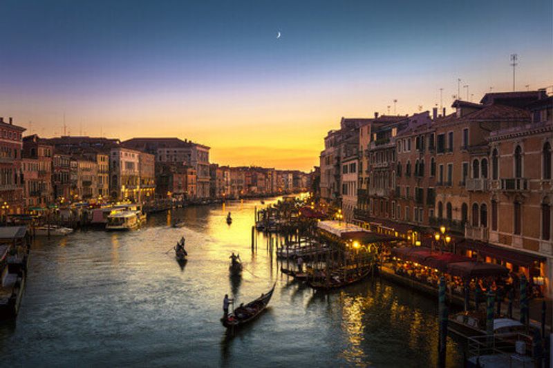 The famous view of the grand canal from Rialto Bridge at sunset.