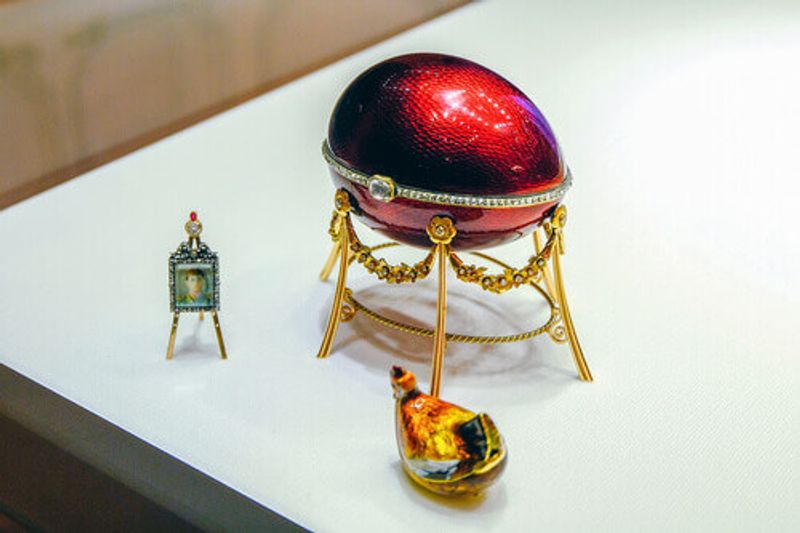 A stunning red faberge egg with a hen.