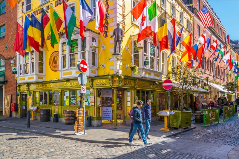 Locals strolling the busy streets of the Temple Bar District of Dublin.