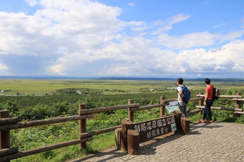 Two male tourists viewing the Kushiro Wetlands at the Hosooka Observatory Deck.
