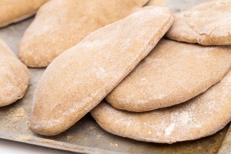 Loaves of traditional Egyptian brown pita bread called Aish Baladi