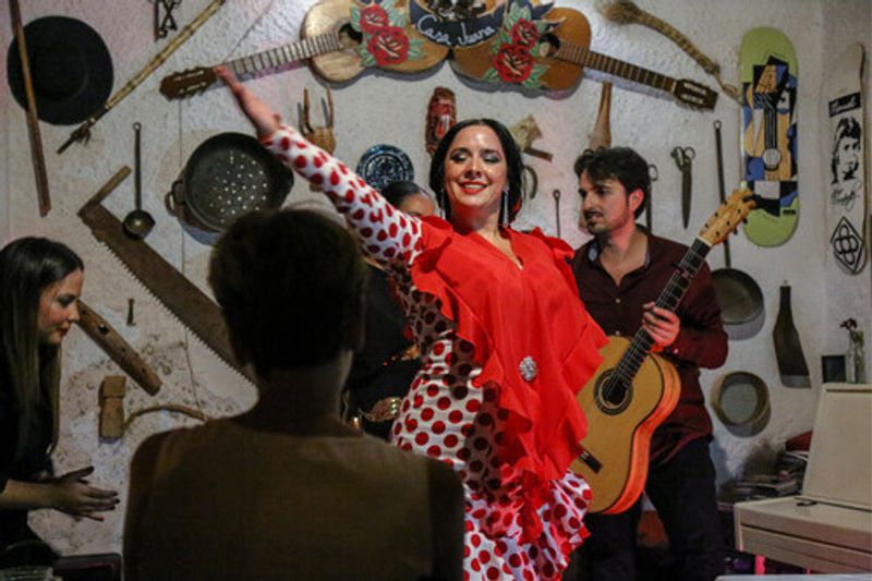 An authentic flamenco show featuring a young gypsy dancer in a red dress in Granada, Spain.