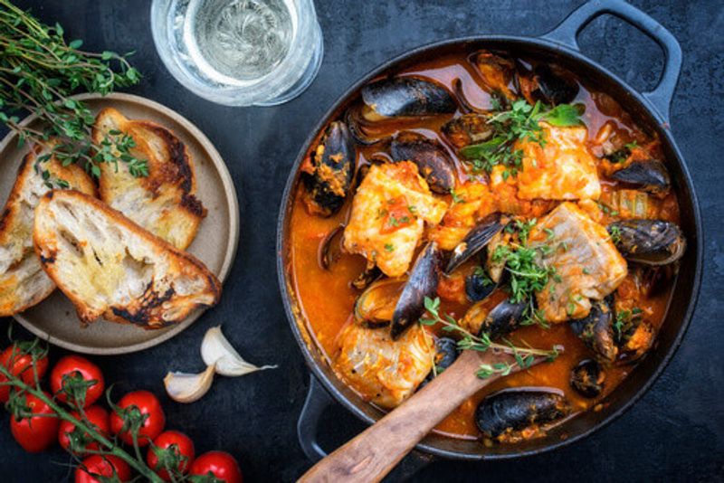 Bouillabaisse a traditional French Corsican seafood stew with mussels and garlic baguette