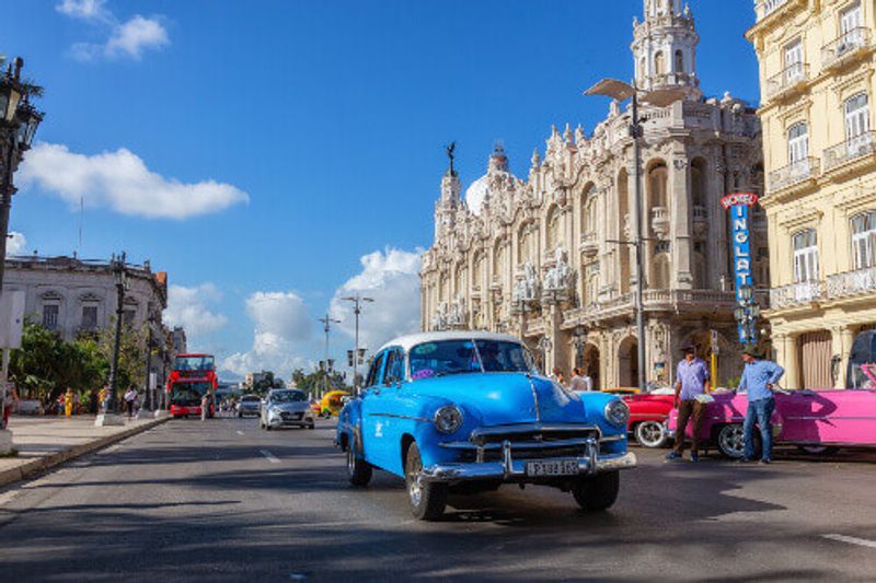 A classic car in the streets of the Old Havana City during a sunny morning.