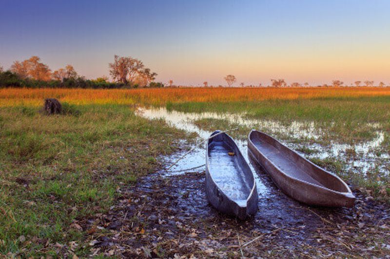 Visitors can enjoy the Okavango Delta in Botswana with a traditional Mokoro canoe ride.