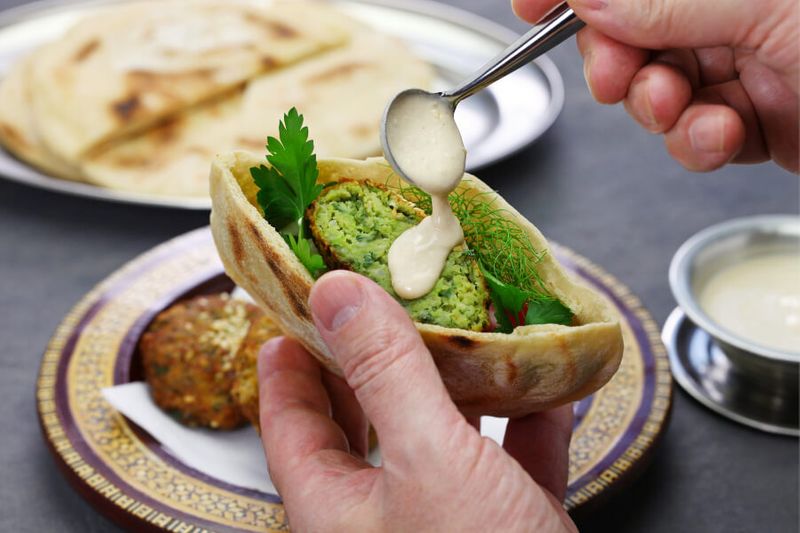 Taameya or Egyptian Falafel made from fava beans served inside a pita bread with tahini sauce