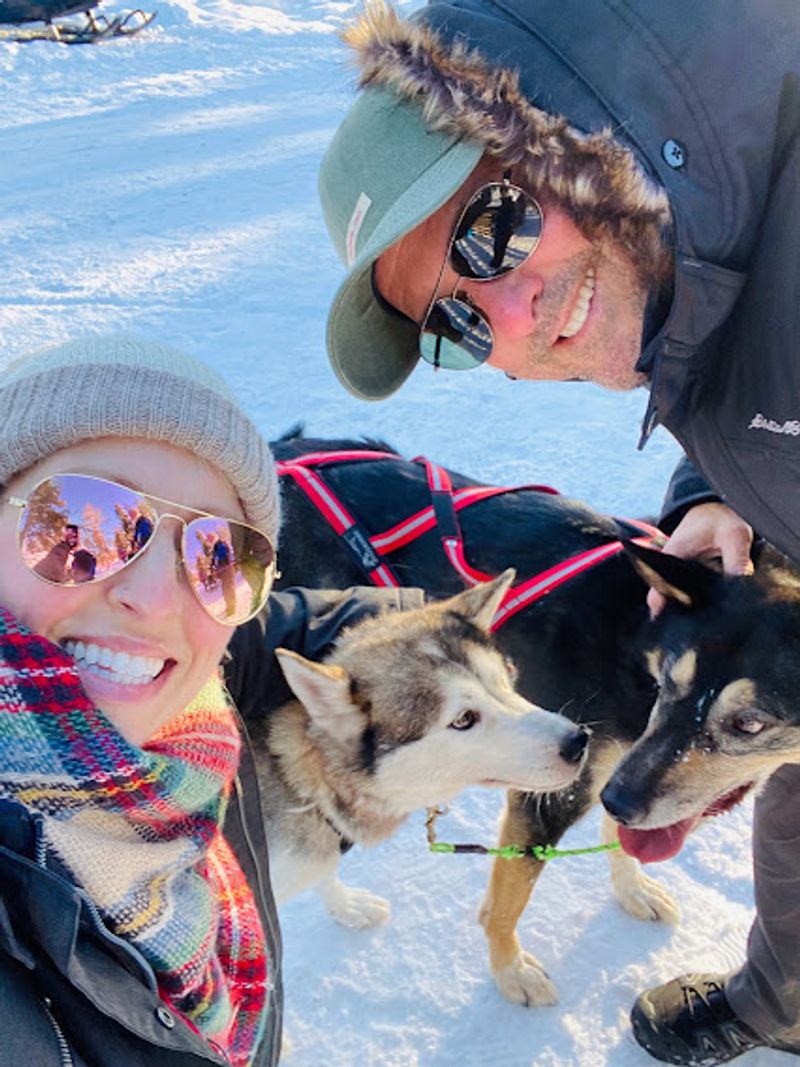 Kristy and Paul with huskies (photo taken by Kristy on tour)