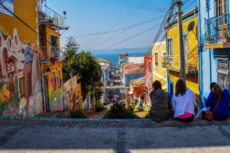 Young women enjoy the view of the streets of Valparaiso, Chile.