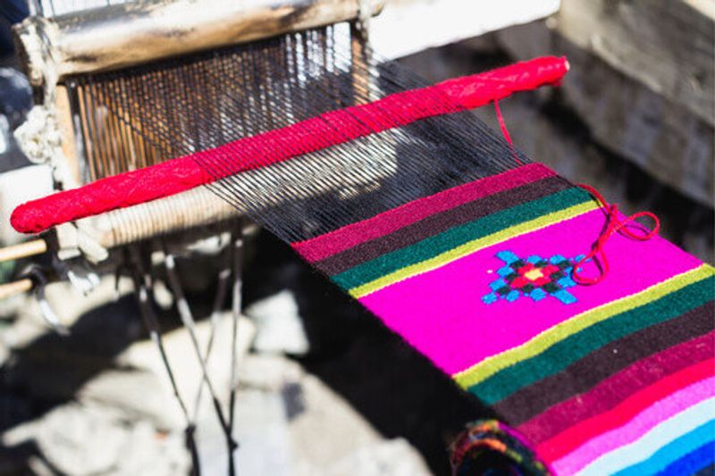 The process of handmade knitting of traditional colorful yak wool shawls on the Nepalese tourist souvenir market.