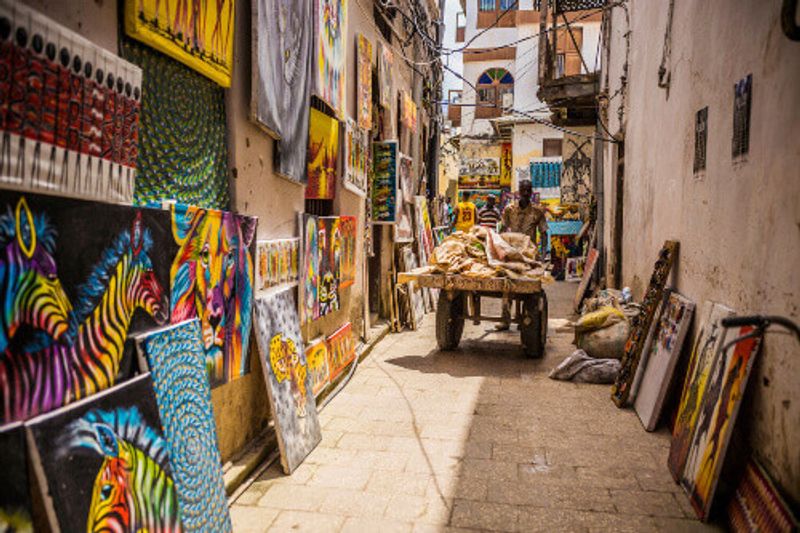 Narrow streets, old houses and people in Zanzibar.