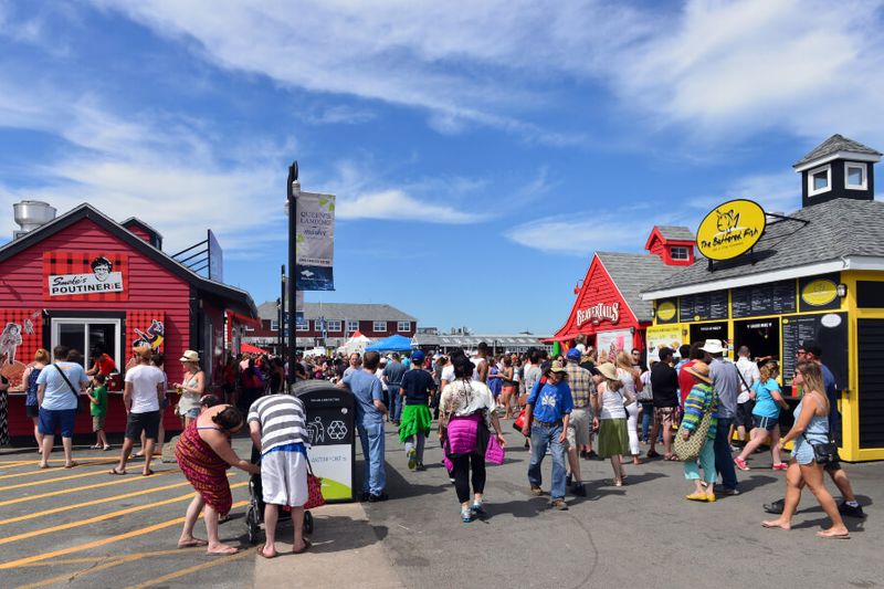 The historic Halifax waterfront with tourists buying poutine and going about their day