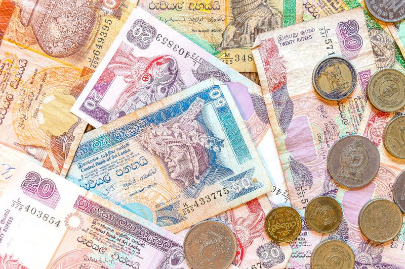 Sri lanka banknotes and coins on a table.