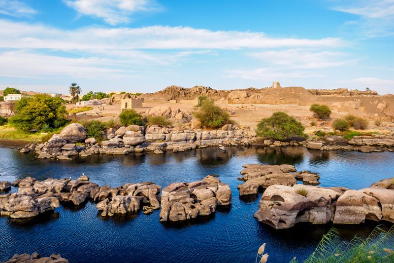 The banks of Nile river with rock formations in the morning