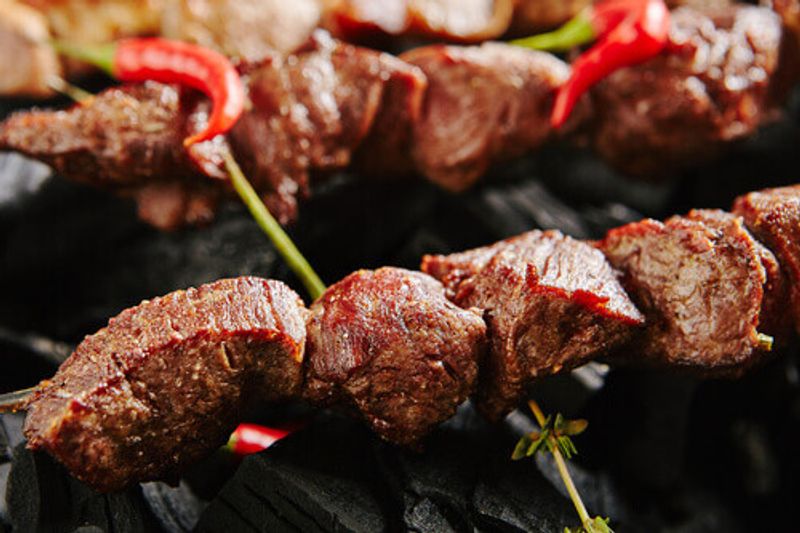 Hot Grilled Beef Kebab, or Russian Barbecue Shashlik with herbs and spices.