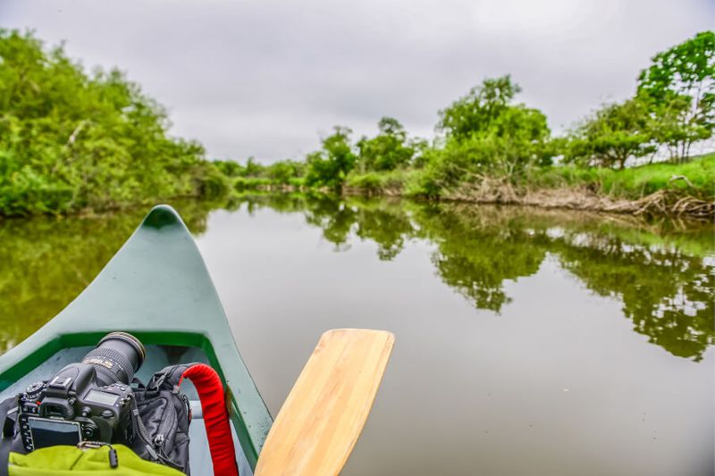A photographer canoeing in the Kushiro Marsh Area