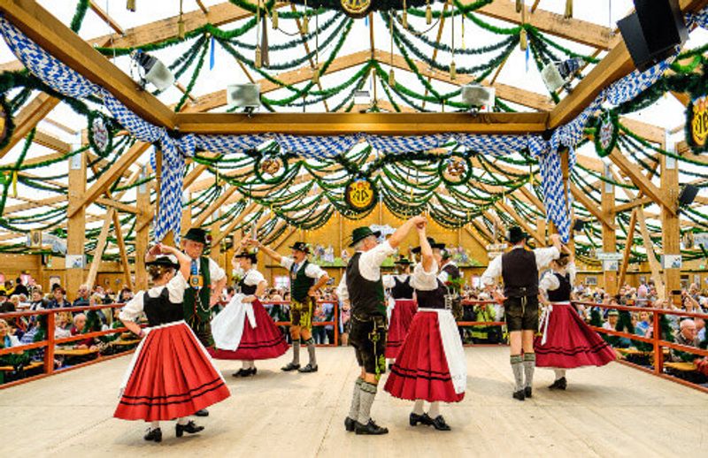 Locals in their traditional clothing at a beer tent in the biggest folk festival in the world, Oktoberfest.