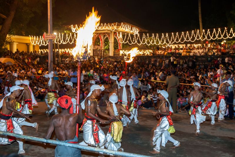 Pathuru dancers perform in front of a huge crowd at the Esala Perahara