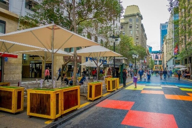 A crowd of people walking in the Plaza de las Armas square in Santiago, Chile.