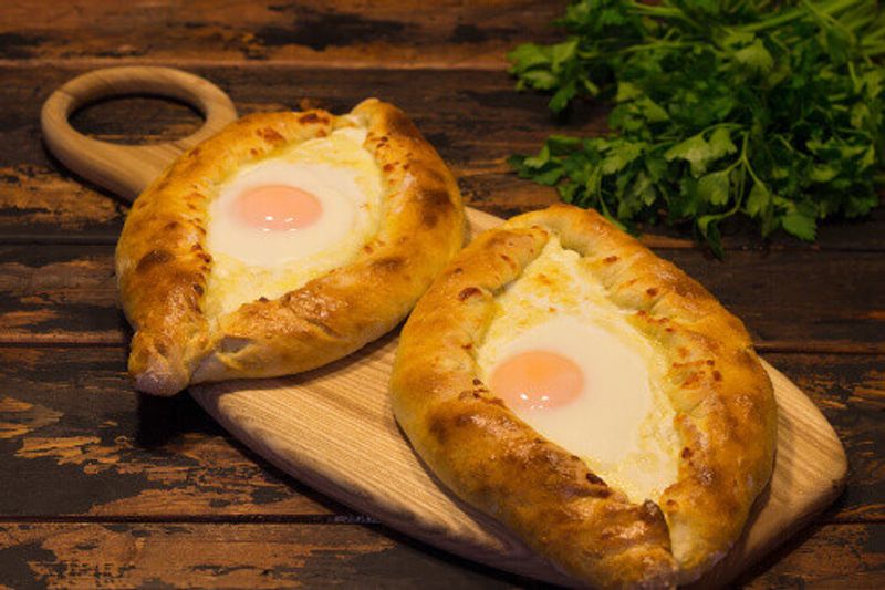 The Georgian national dish called Khachapuri, a Batumi style open pastry with white cheese topped with egg yolk and butter.
