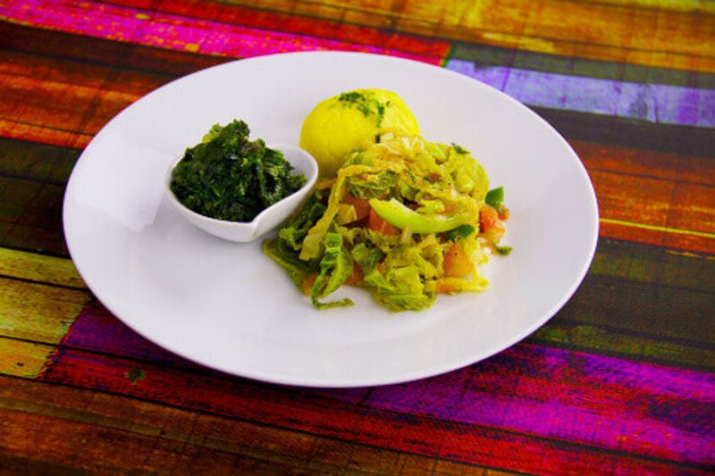 A Kenyan traditional cabbage dish with sukuna wiki and ugali or maize.