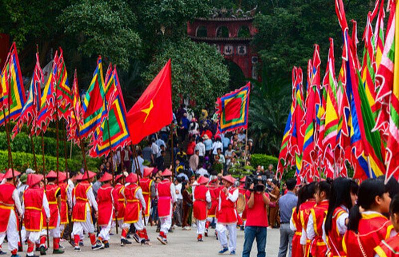 A procession of people in traditional clothing in Phu Tho, Vietnam.