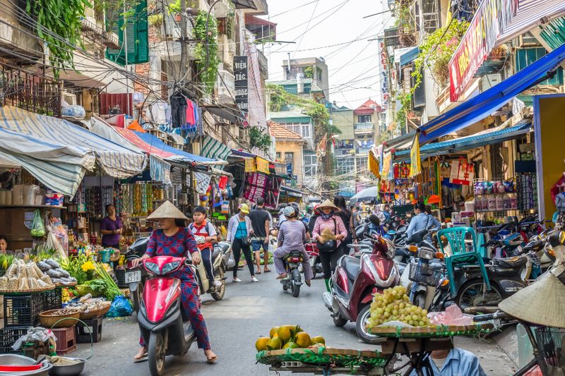 The busy daily life of a street market in Hanoi.