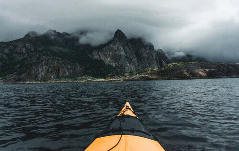A small yellow kayak in a bay on the Lofoten Islands, Norway.