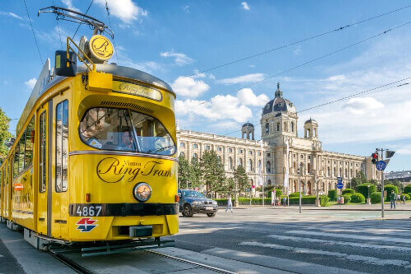 The nostalgic yellow Vienna Ring Tram in front of Kunsthistorisches Museum on Ringstrasse in Vienna.