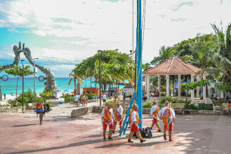 The Voladores of Papantla dressed in traditional clothing performong  for tourists.