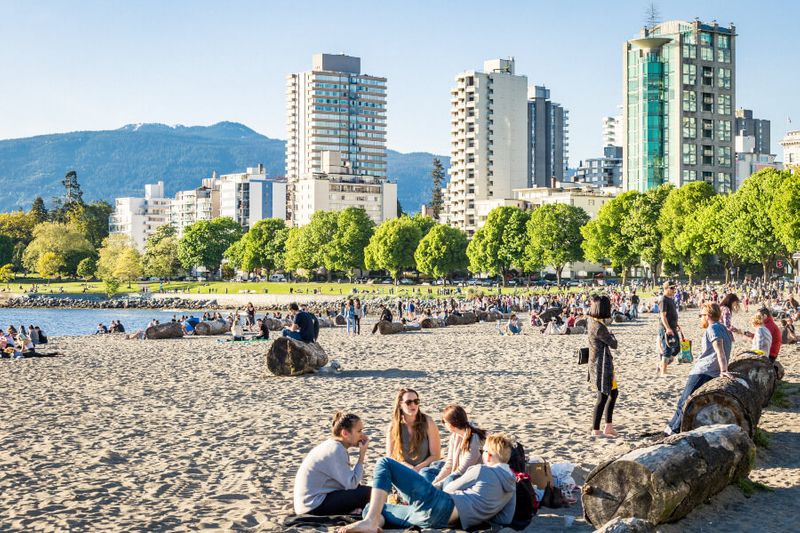 Hundreds of locals and tourists resting along the Sunset Beach and English Bay.
