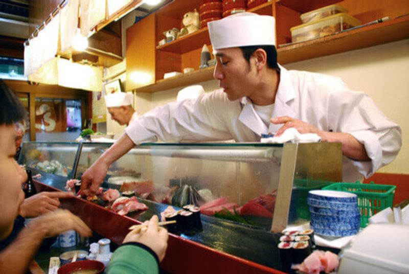 A sushi master at the Sushi Daiwa, Tokyo, Japan.